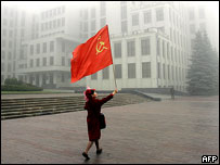 Communist Party supporter with flag, Minsk central square, 2005 