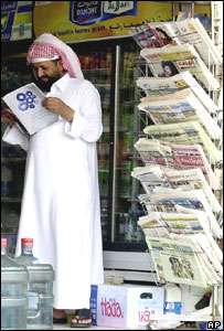 Saudi reader at news stand