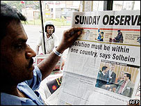 Reader with a Sri Lankan newspaper