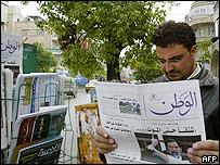 Reader scans a Syrian newspaper