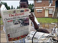 Newspaper vendor reads Harare's main daily