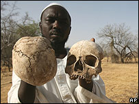 Darfur villager shows skulls from mass grave
